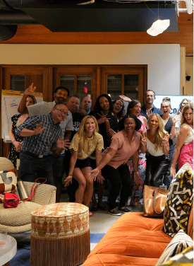 Darryll Stinson with a diverse group of people at an event, smiling and enjoying the moment.