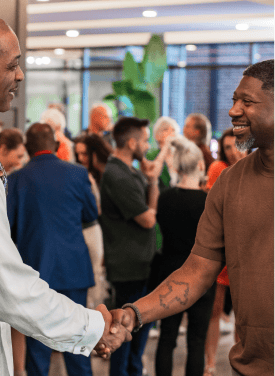 Darryll Stinson shaking hands at a professional event.